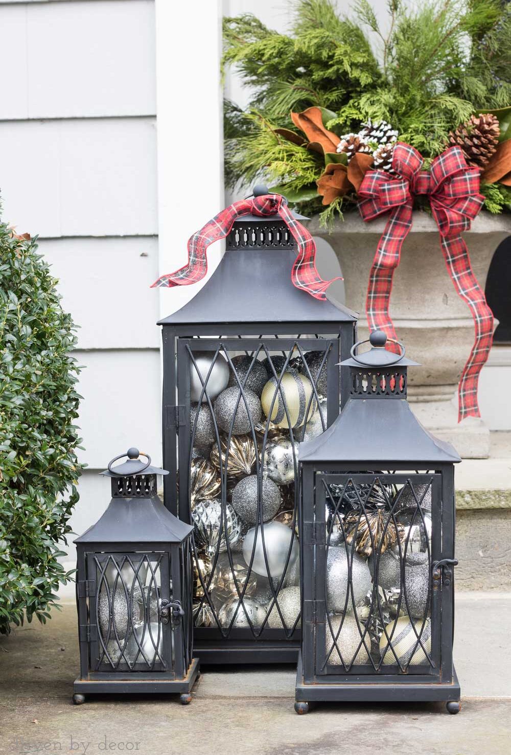 Love the idea of filing lanterns with ornaments to decorate your porch for Christmas!