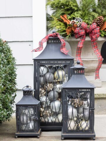 Love the idea of filing lanterns with ornaments to decorate your porch for Christmas!