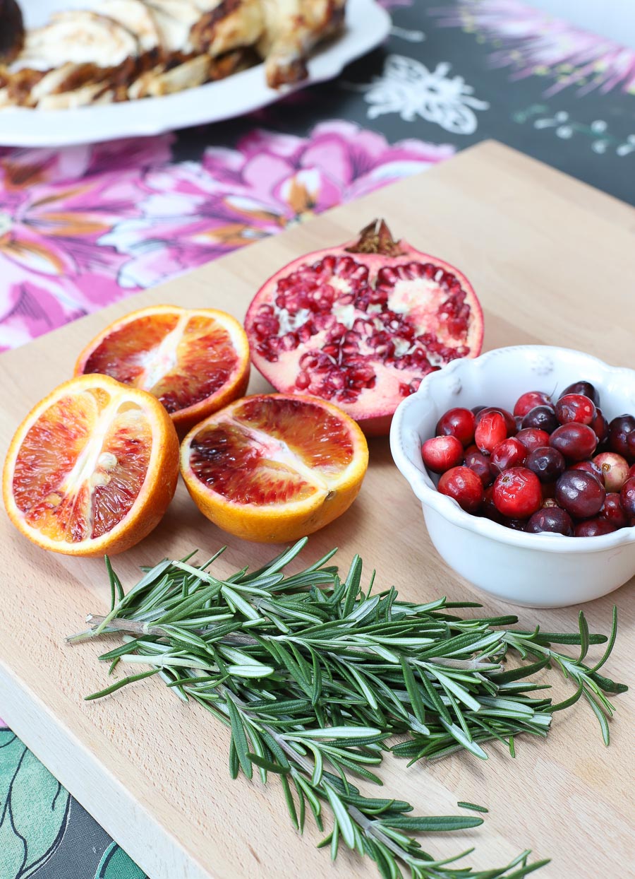 Pomegranates, blood oranges, cranberries, and fresh rosemary are used to dress up a rotisserie chicken. See more in the post!