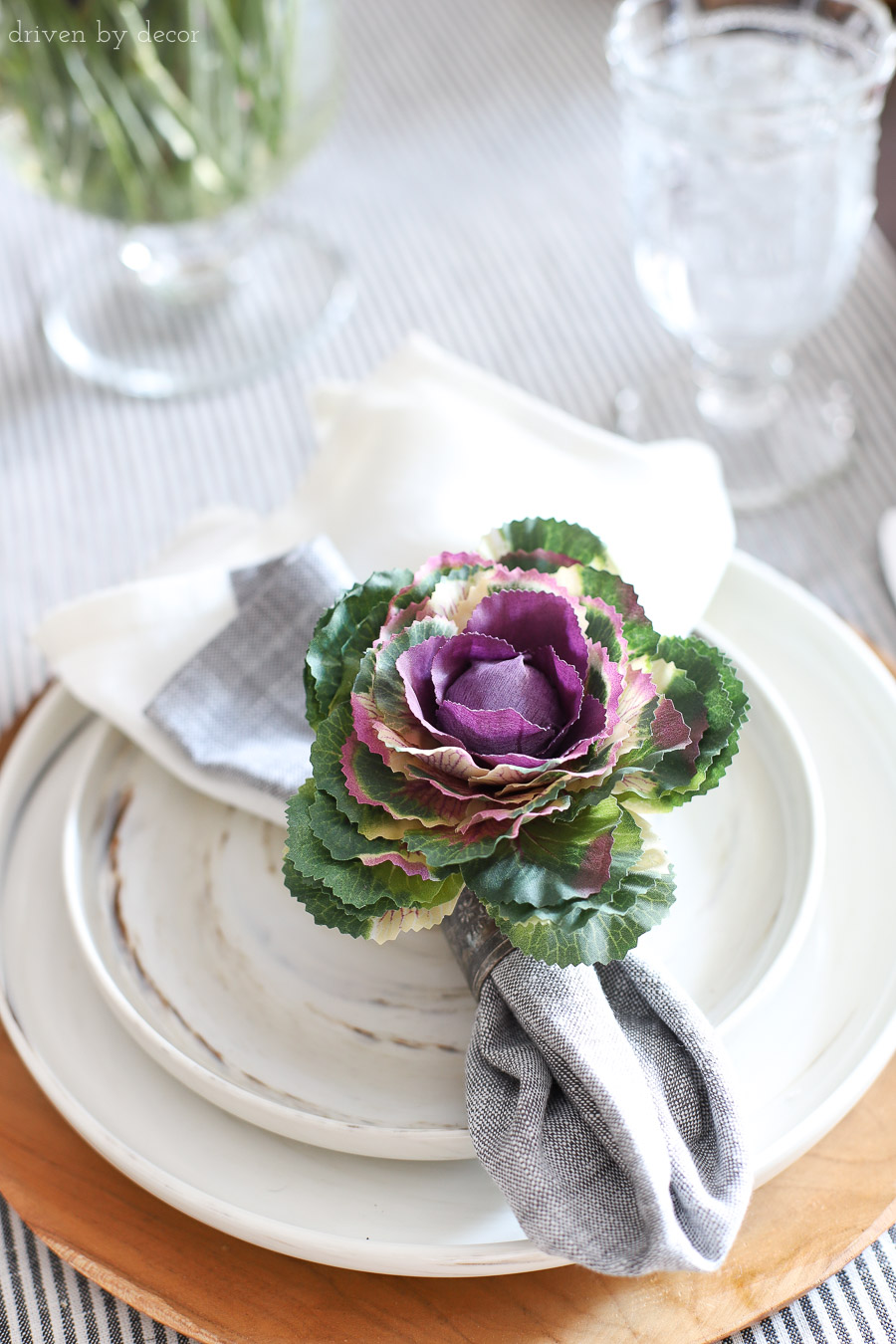 Faux kale step tucked into a napkin ring - a simple, perfect placesetting for fall or Thanksgiving!