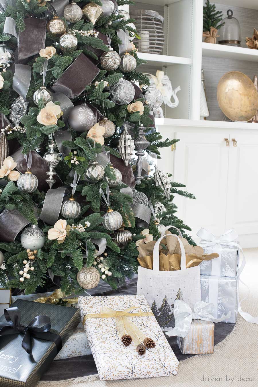 Beautiful Christmas tree with velvet ribbon and metallic ornaments along with gorgeously wrapped presents! 