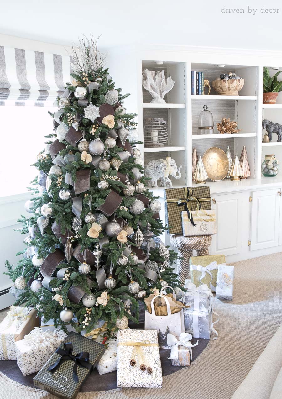Love this Christmas tree! Decorated with wide gray velvet ribbon, silver ornaments, berries, and flowers!
