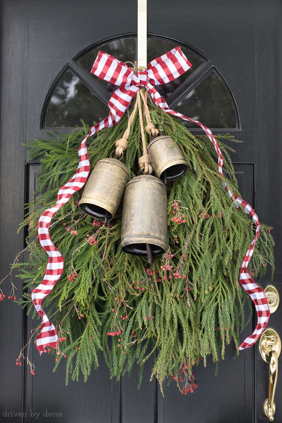 Our front door Christmas decoration - a greenery swag with bells and ribbon instead of a wreath!