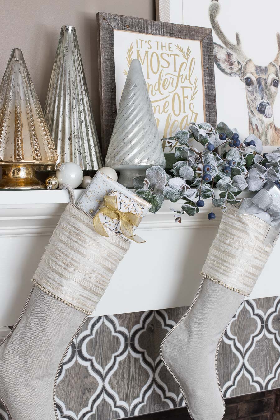 Linen stockings and silver and gold trees were used to decorate this fireplace mantel for Christmas!