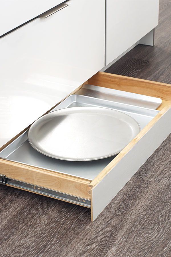 LOVE this toekick drawer - such a smart use of the bottom of your kitchen cabinets! Perfect for holding trays and cutting boards!