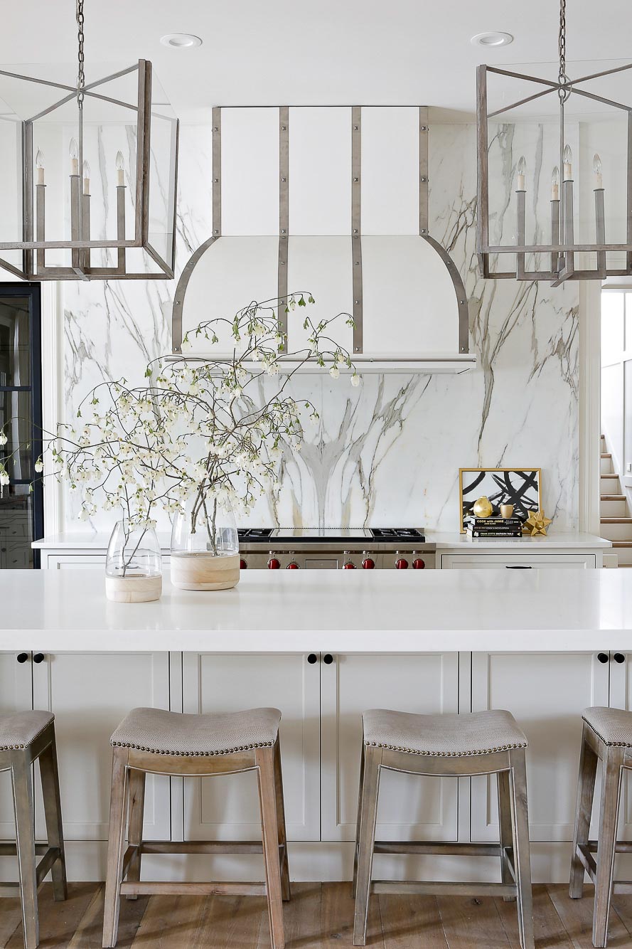 Gorgeous all white kitchen with silver / chrome accents designed by Lori Paranjape
