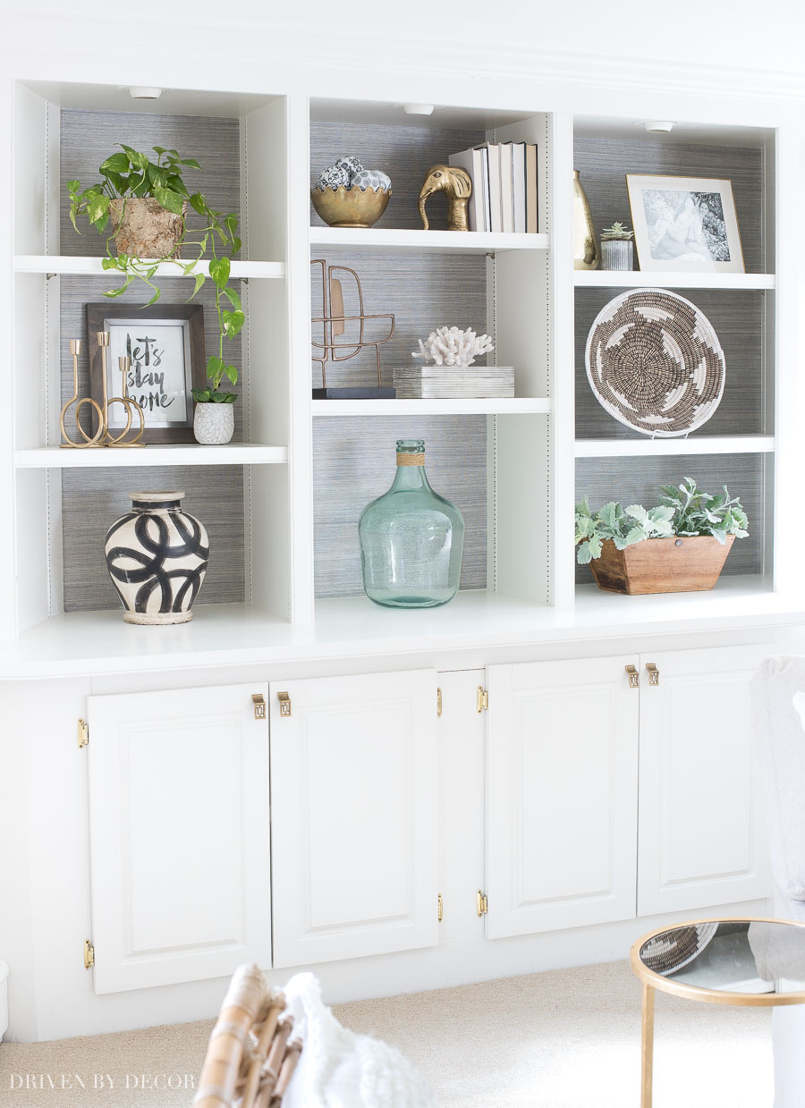 Loving the charcoal grasscloth added to the back of these bookcases!