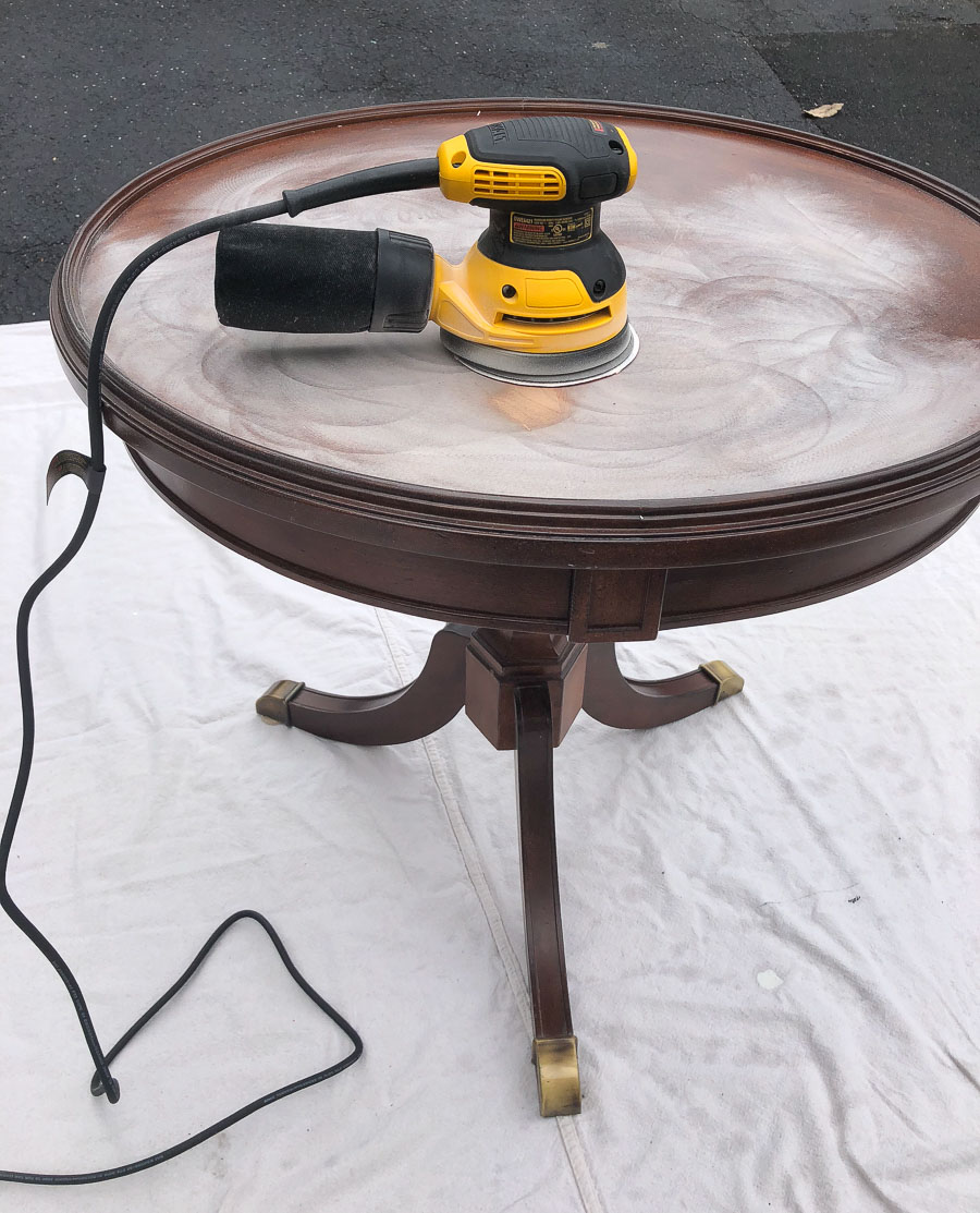 Removing old finish and scratches from a piece of furniture with an orbital sander