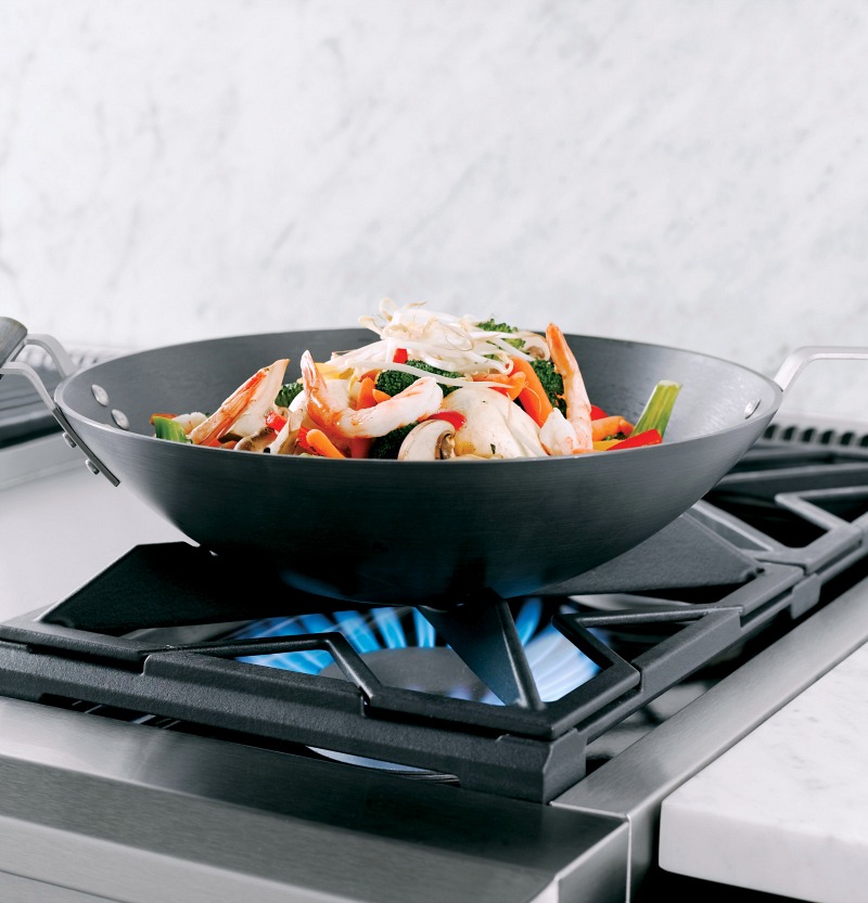 This Monogram range has flat burners that reverse to contoured burners for cradling a wok - so smart!