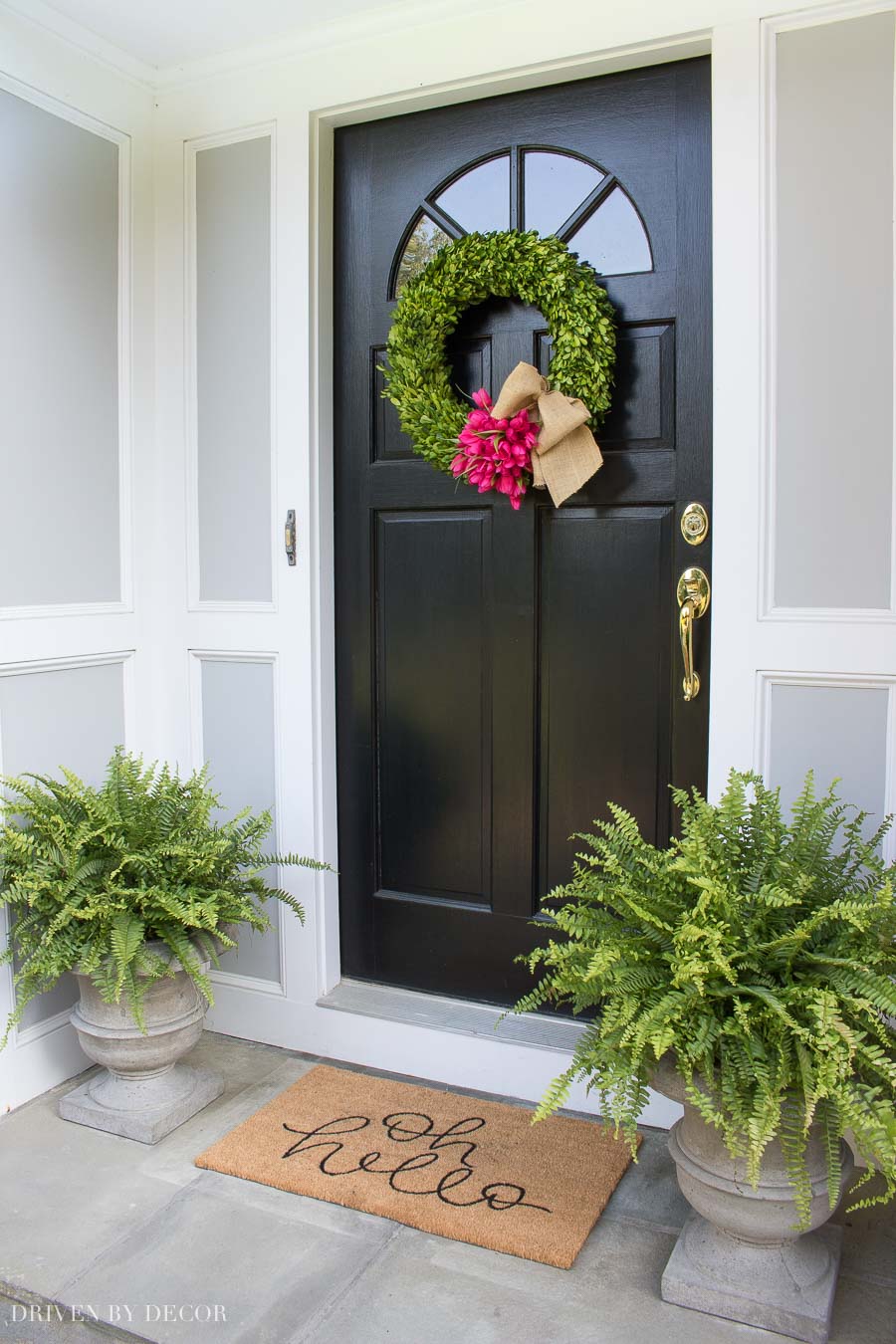 Loving the simple spring door decorations of a boxwood wreath with tulips and planters with Boston ferns!