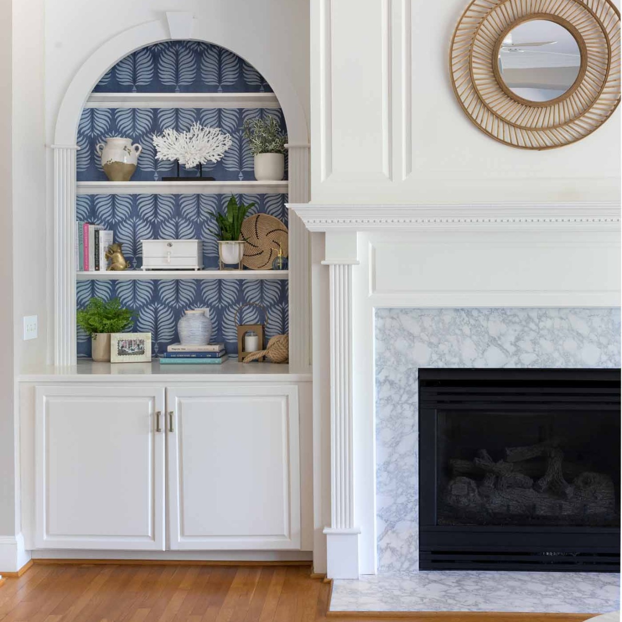 Love the look of a simple rattan mirror above the fireplace!