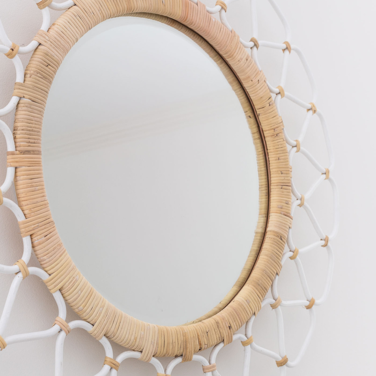 Love this rattan mirror that she put above the bed!