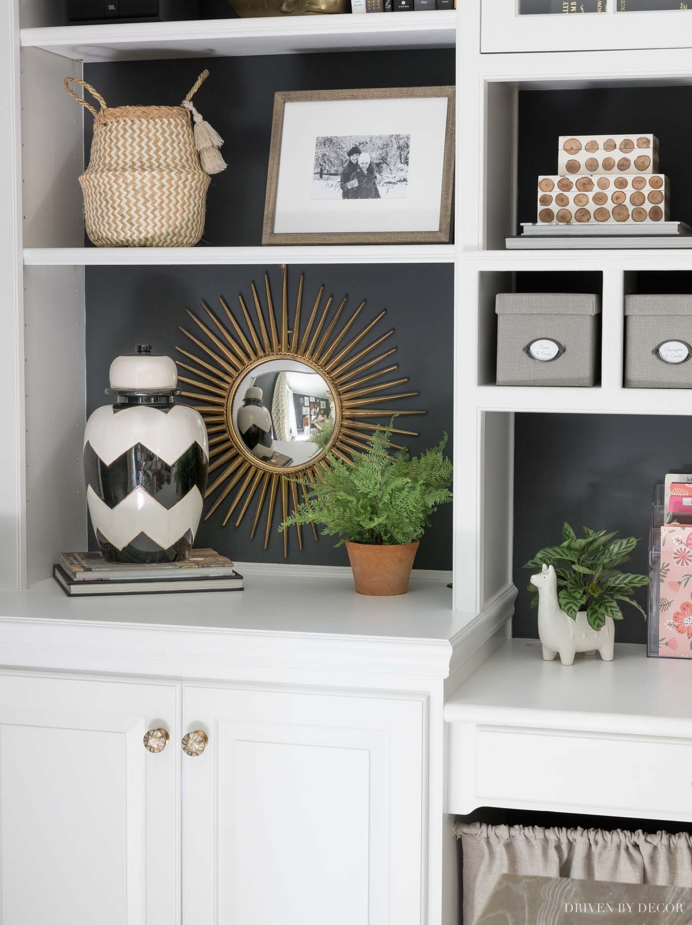 Love the starburst mirror she has on the back of her bookcase!