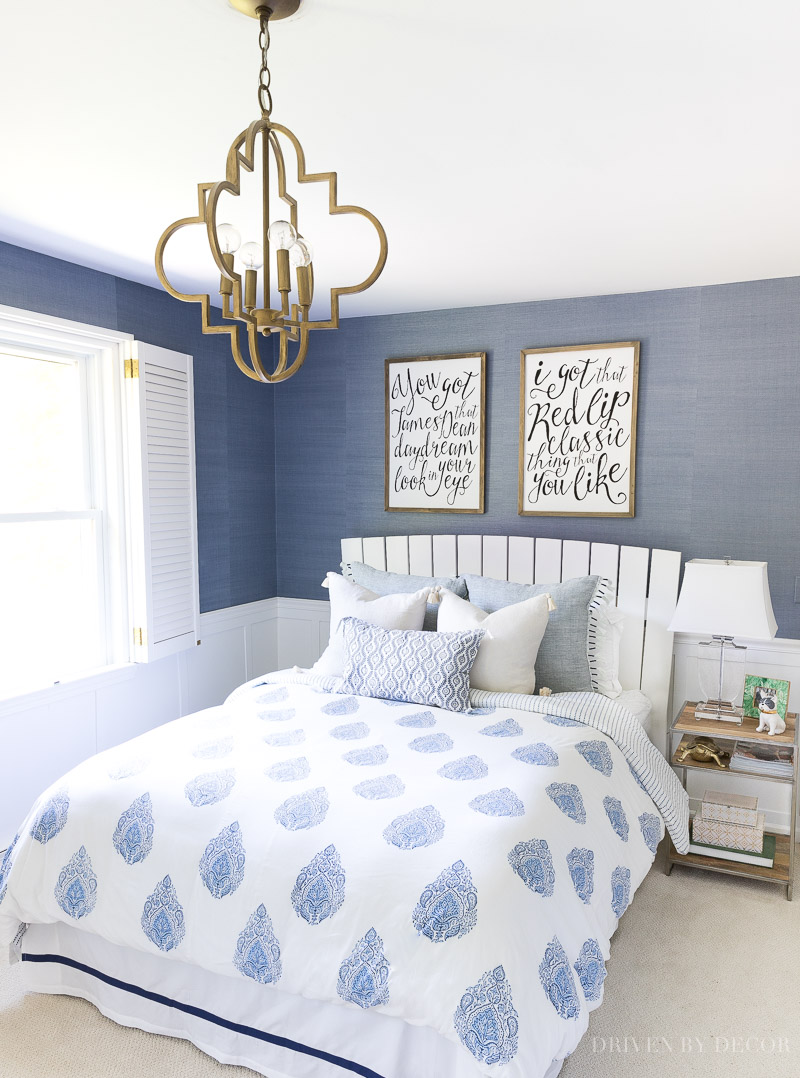 Loving this blue and white bedroom with block print bedding, grasscloth wallpaper, Taylor Swift wall art, and quatrefoil pendant lighting!