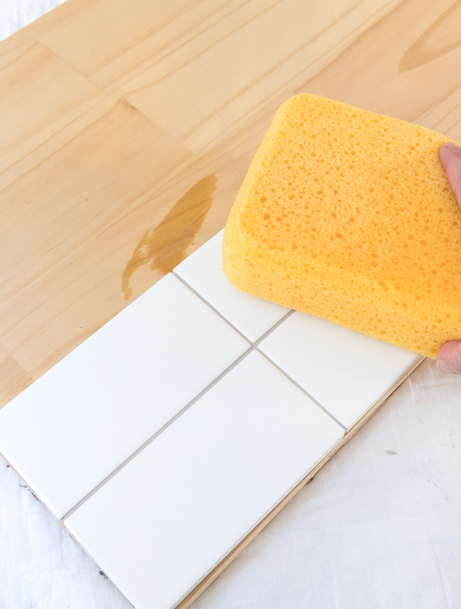 Use a sponge as a final step to clean your tile and remove excess grout - the last step in creating a tile sample board to choose your grout color!