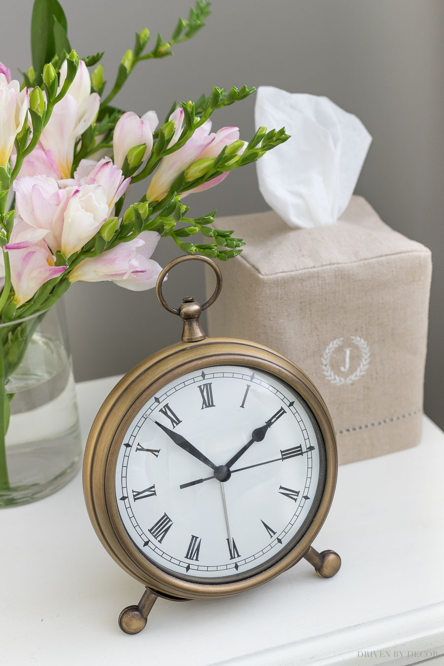 Must-haves for your guest bedroom nightstand - a clock (love this one!) and a box of tissues (love this pretty tissue box cover!)