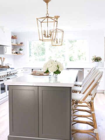 The makeover reveal of our new gray and white kitchen with quartz countertops, Monogram appliances, gold accents, and gorgeous floors! Love!