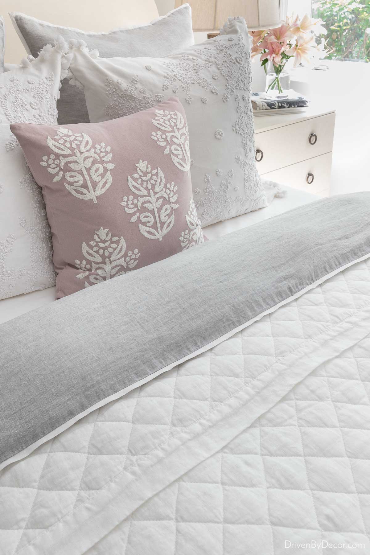 White quilt as a layer of guest room bedding