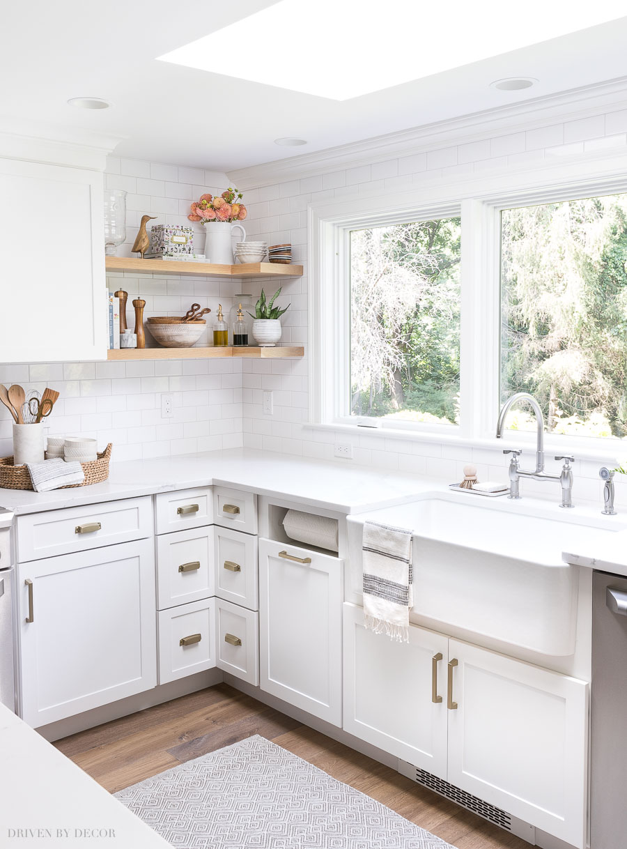 Love this long wall of windows and the open wood shelving that wraps around the corner!