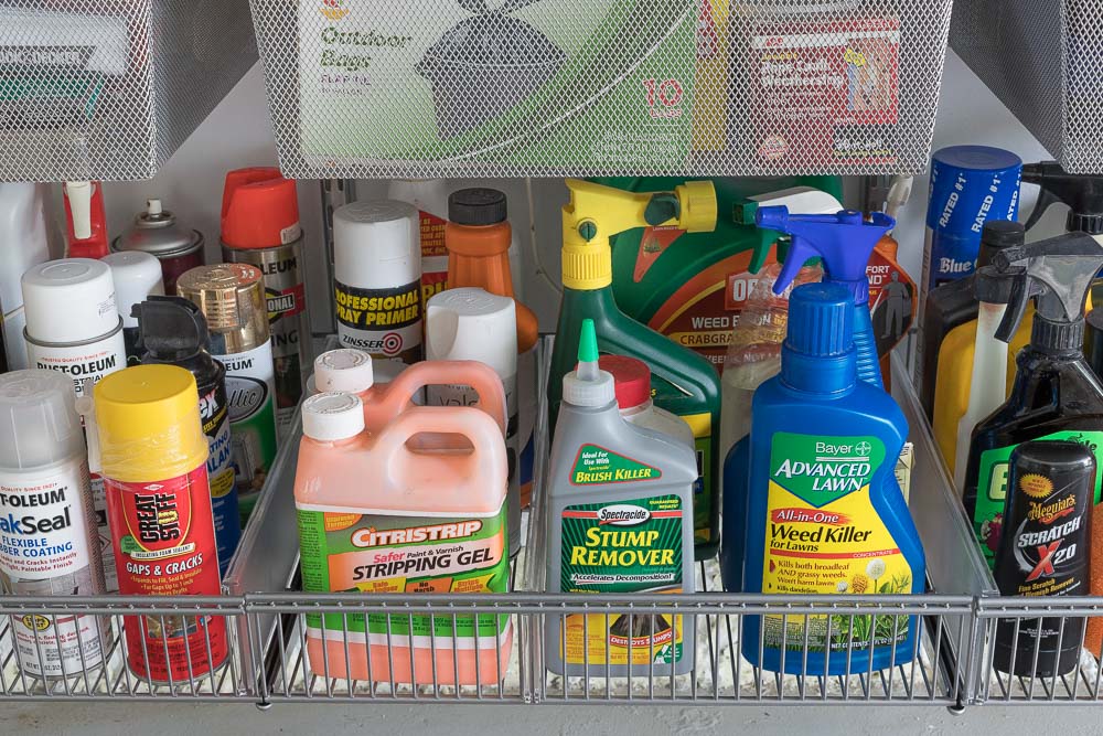 Efla shelf baskets neatly organize all of the bottles and spray cans in this newly organized garage!