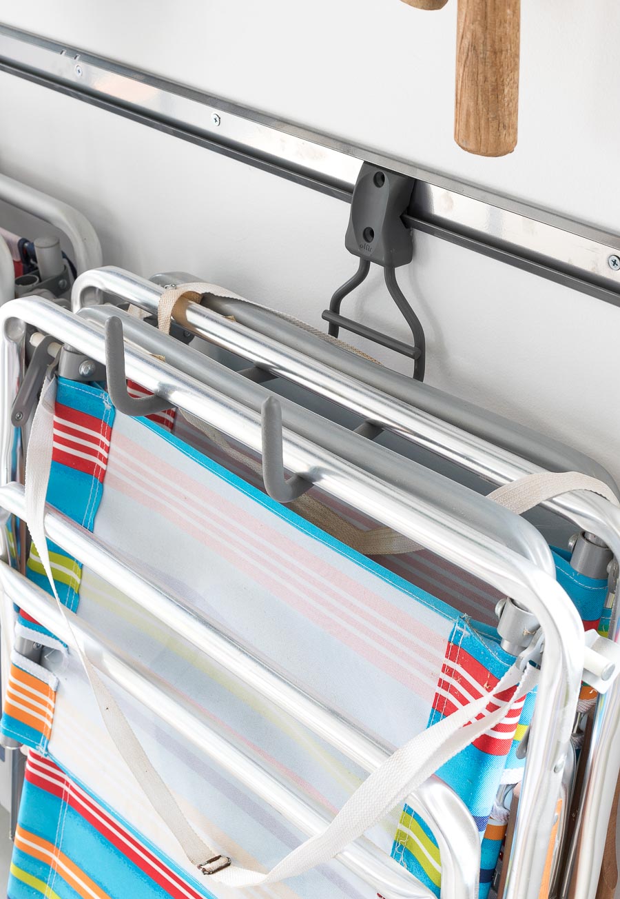 Definitely a garage must-have! These Elfa wide ladder hooks are perfect for holding folding chairs and sawhorses in addition to ladders! Love how this garage is organized!