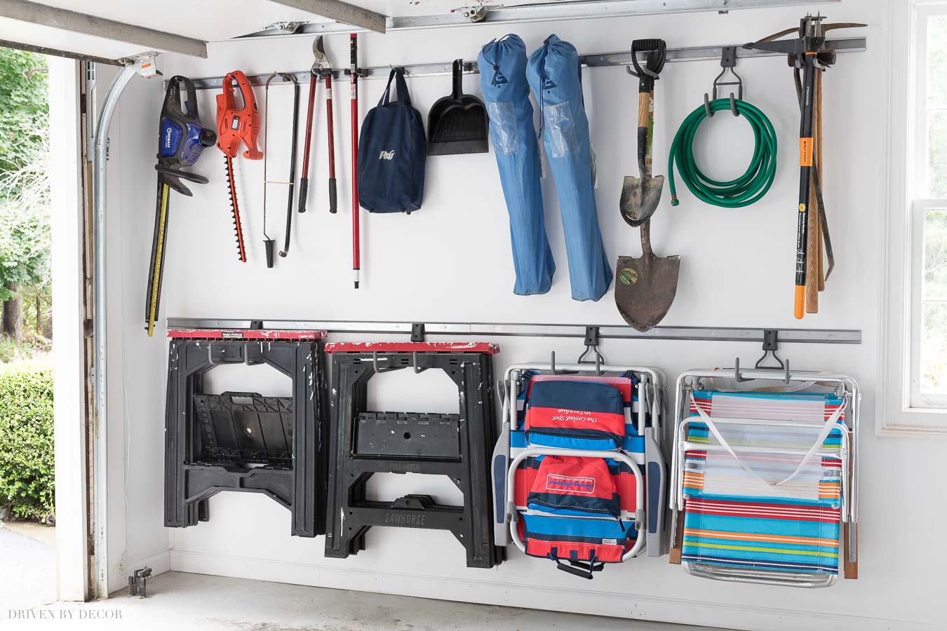 I'm getting so many ideas for organizing our garage from this post! Love this Elfa system for hanging tools!