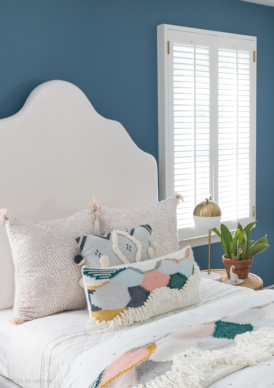 Gorgeous combination of blush and blue pillows and colorful throw in this boho chic bedroom! All sources included in the post!