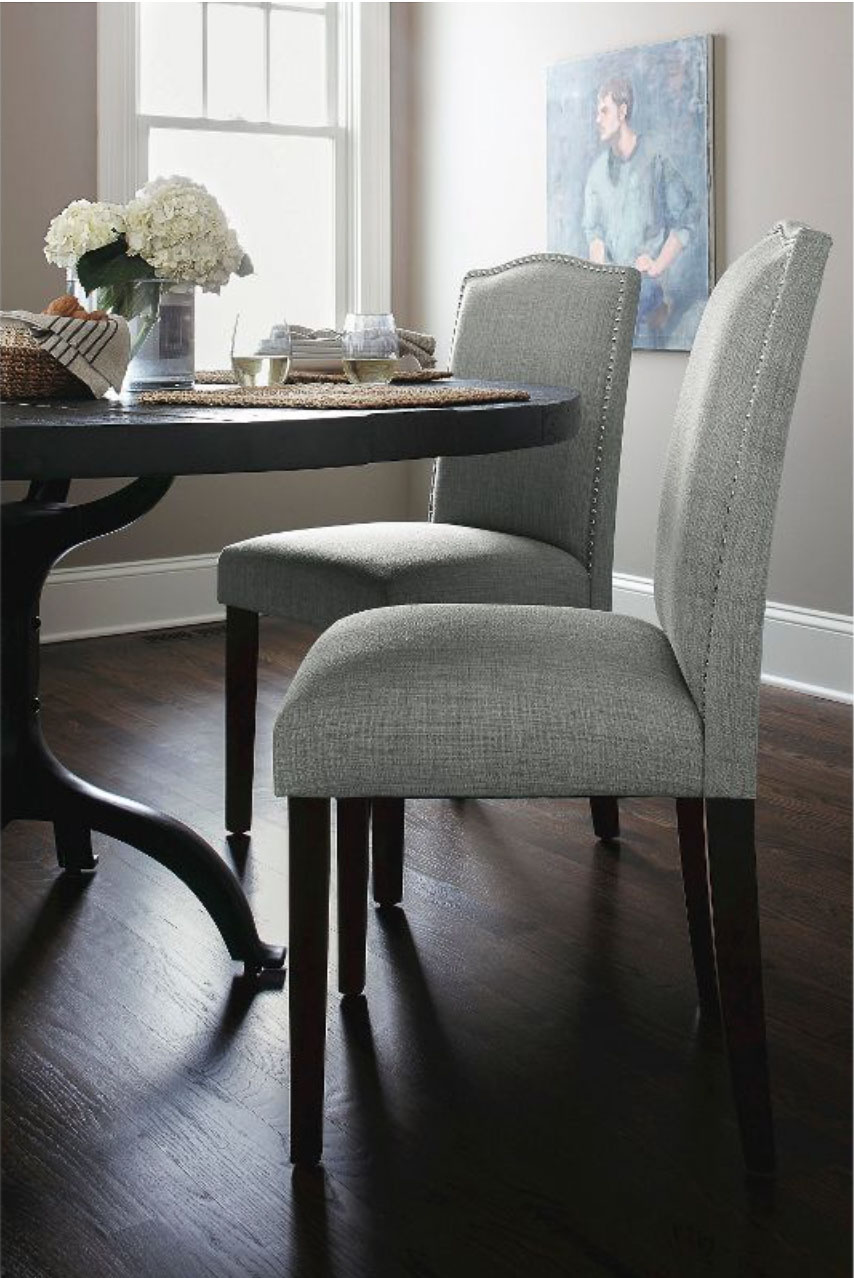 Upholstered gray dining chairs with nailheads