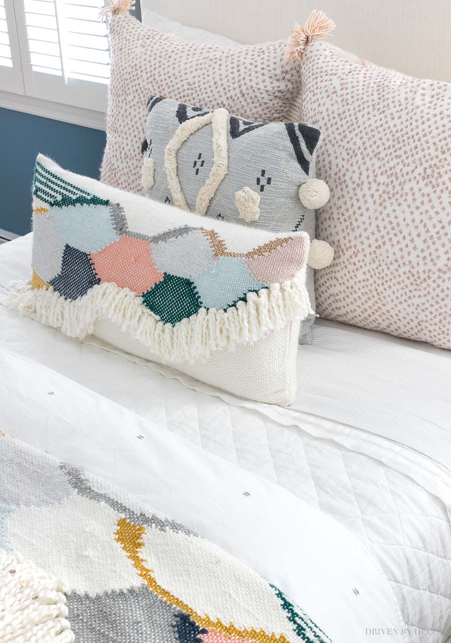 My favorite quilt and a neutral duvet are the foundation for the more colorful pillows in this boho chic bedroom!