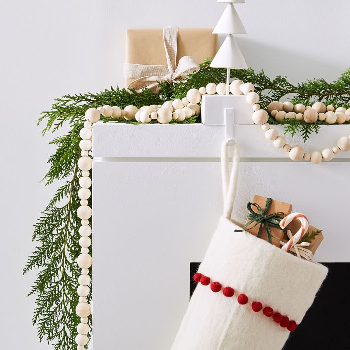 Gorgeous wood bead garland for Christmas! Looks beautiful intertwined with greenery on a mantel!