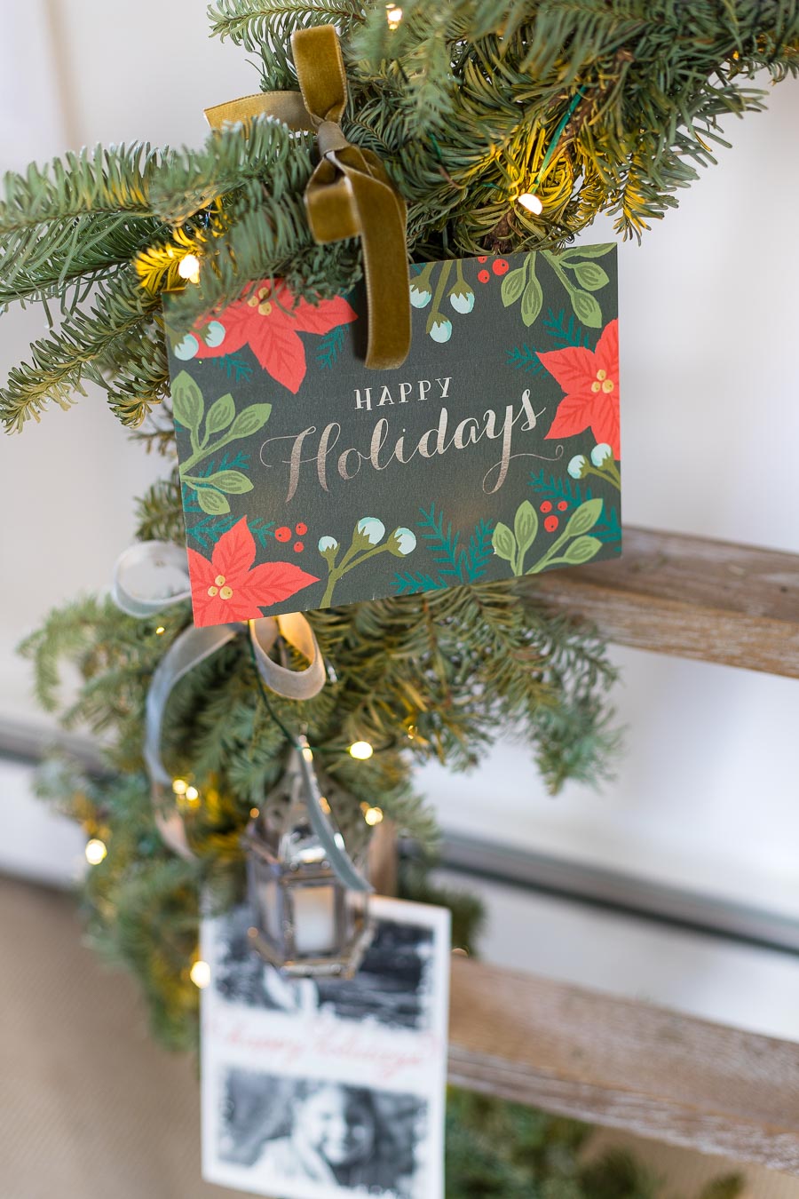 Love this way of displaying Christmas cards by tying them onto a garland wrapped ladder!