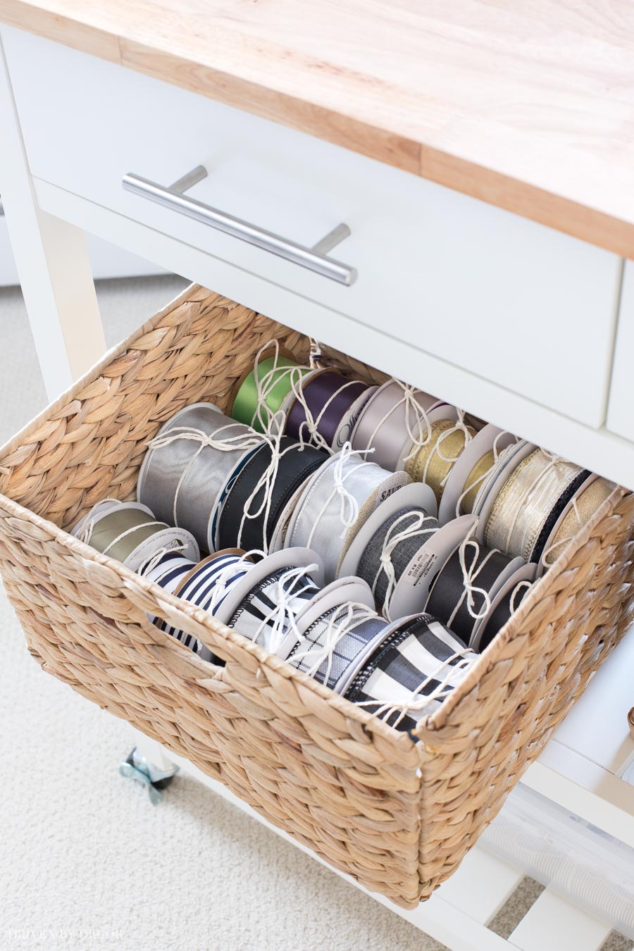 A woven basket holds spools of ribbon in this super cute and functional gift wrapping station!