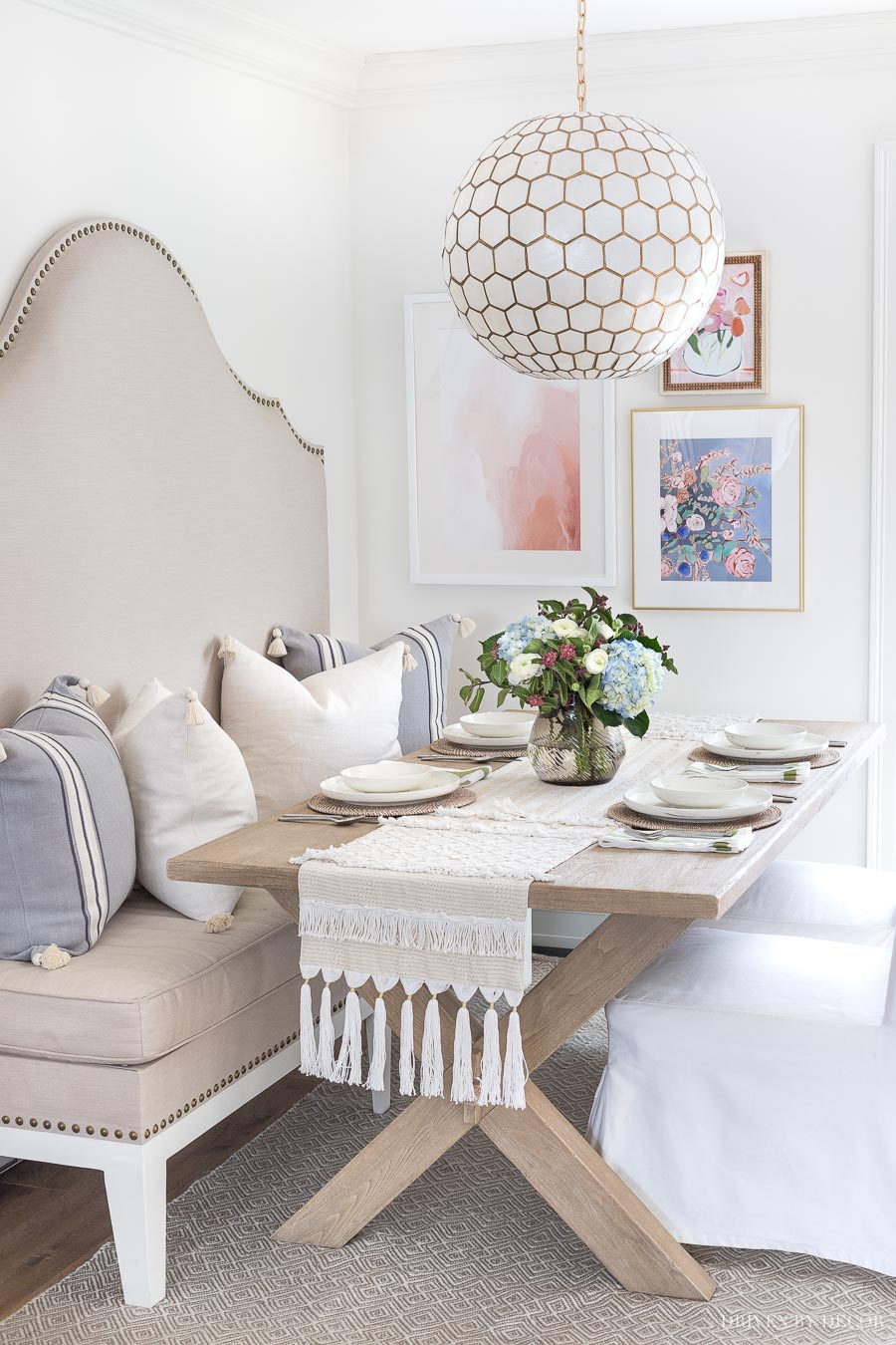 Love this kitchen eat-in area (especially the arrangement of the three pieces of art!)