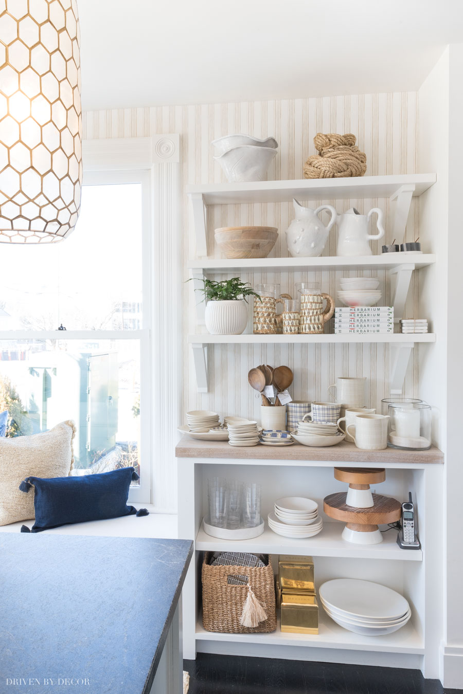 Love the look of this striped wallpaper behind open shelving!