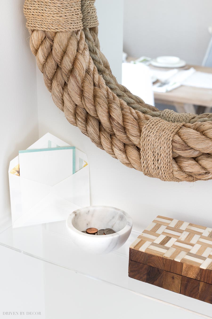 Love this stylish acrylic shelf for holding change, keys, and mail as you go in or out through this entryway!