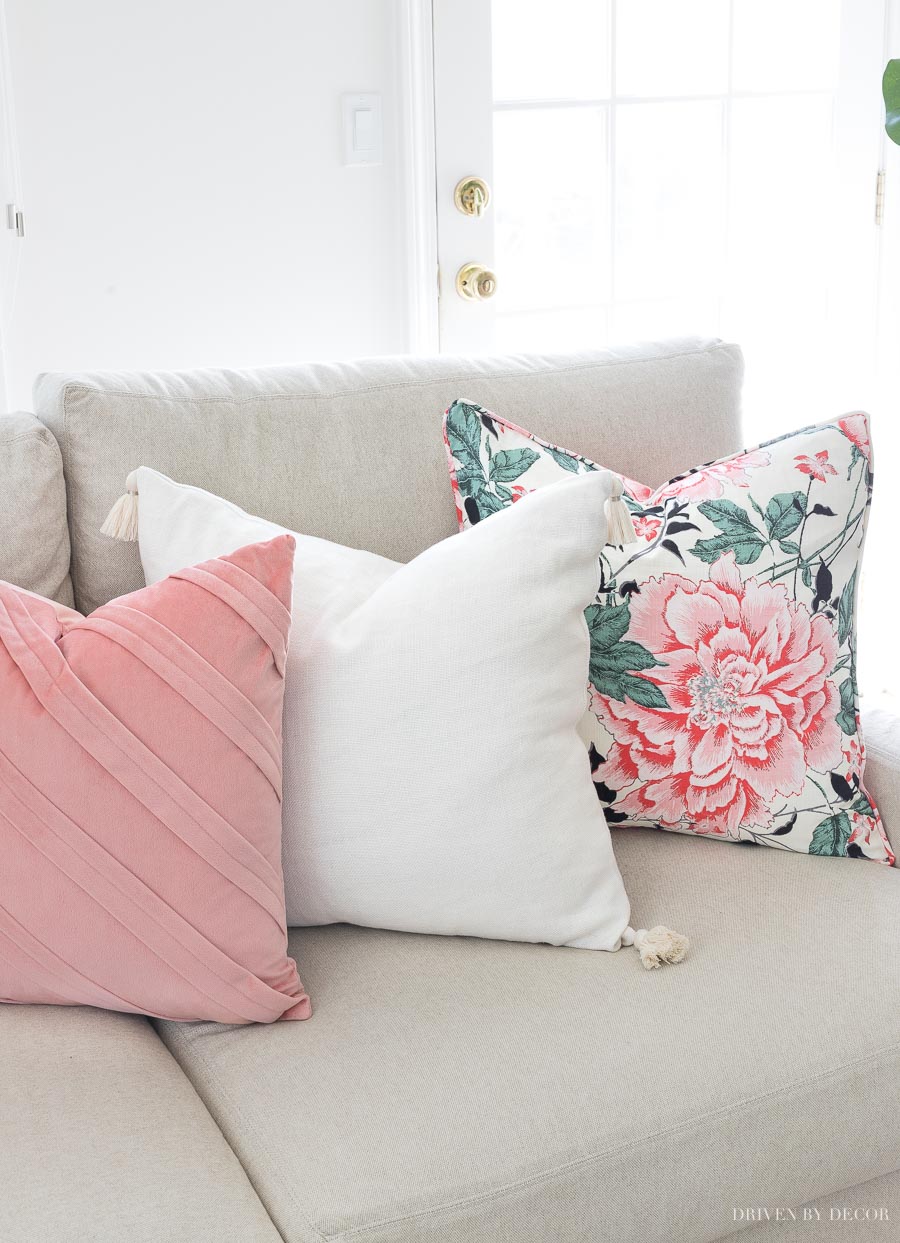 Loving this combination of spring pillows with a floral pattern, solid cream tasseled pillow, and pleated blush velvet!