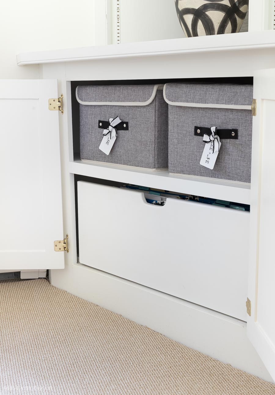 Love these storage ideas! Labeled fabric bins on the shelves above and hanging file folders in a pull-out drawer below!