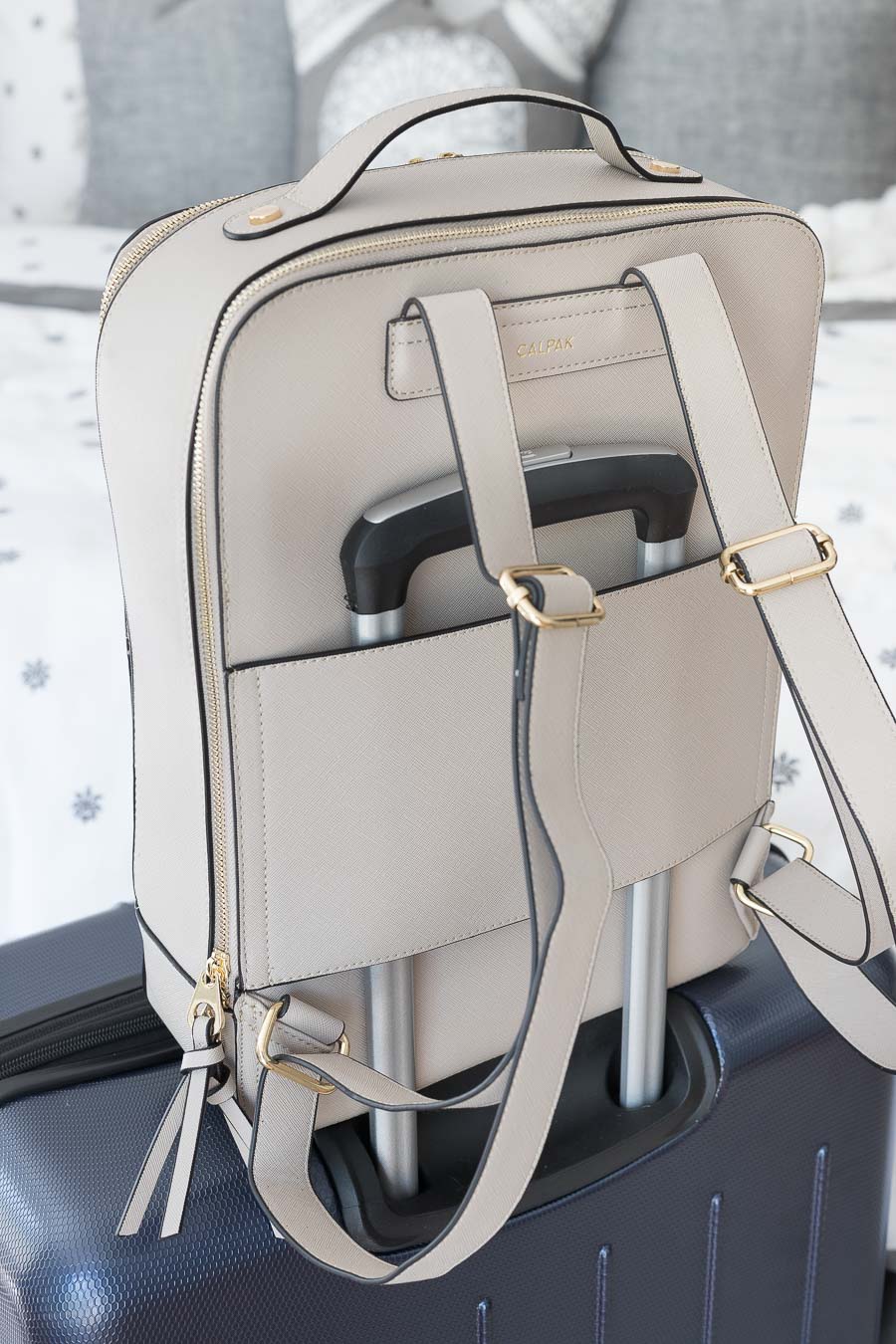 This travel backpack hooks onto the handle of your suitcase!