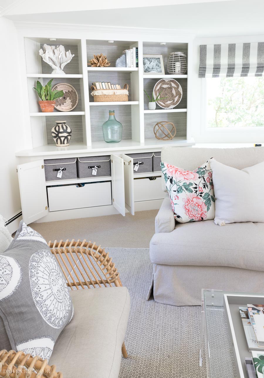 These lidded storage boxes for my pillow covers fit perfectly in the cabinets of our family room bookcase!