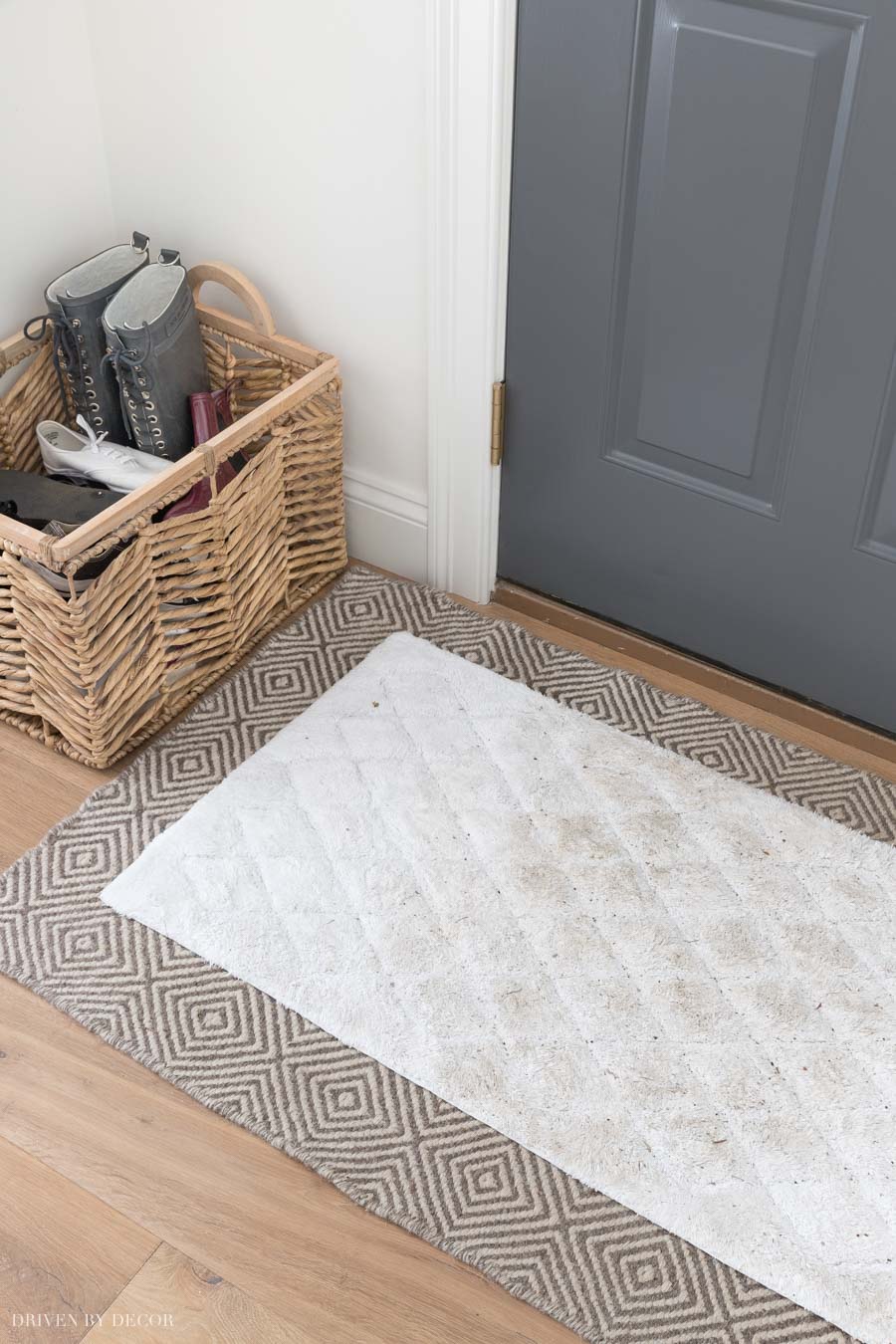 Smart idea to layer an easy to wash doormat over a patterned rug!