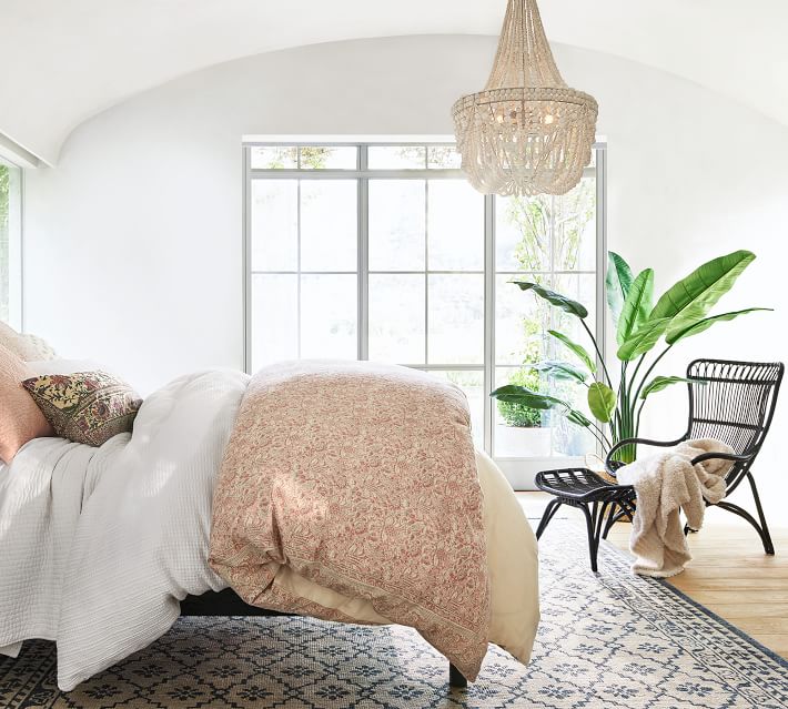 Love the gorgeous draped wood bead chandelier in this bedroom!