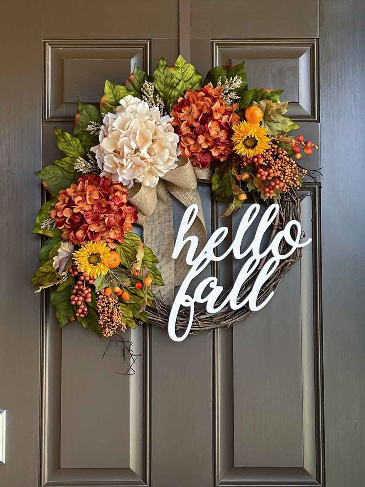 Fall wreath with hydrangeas, sunflowers and cursive hello fall
