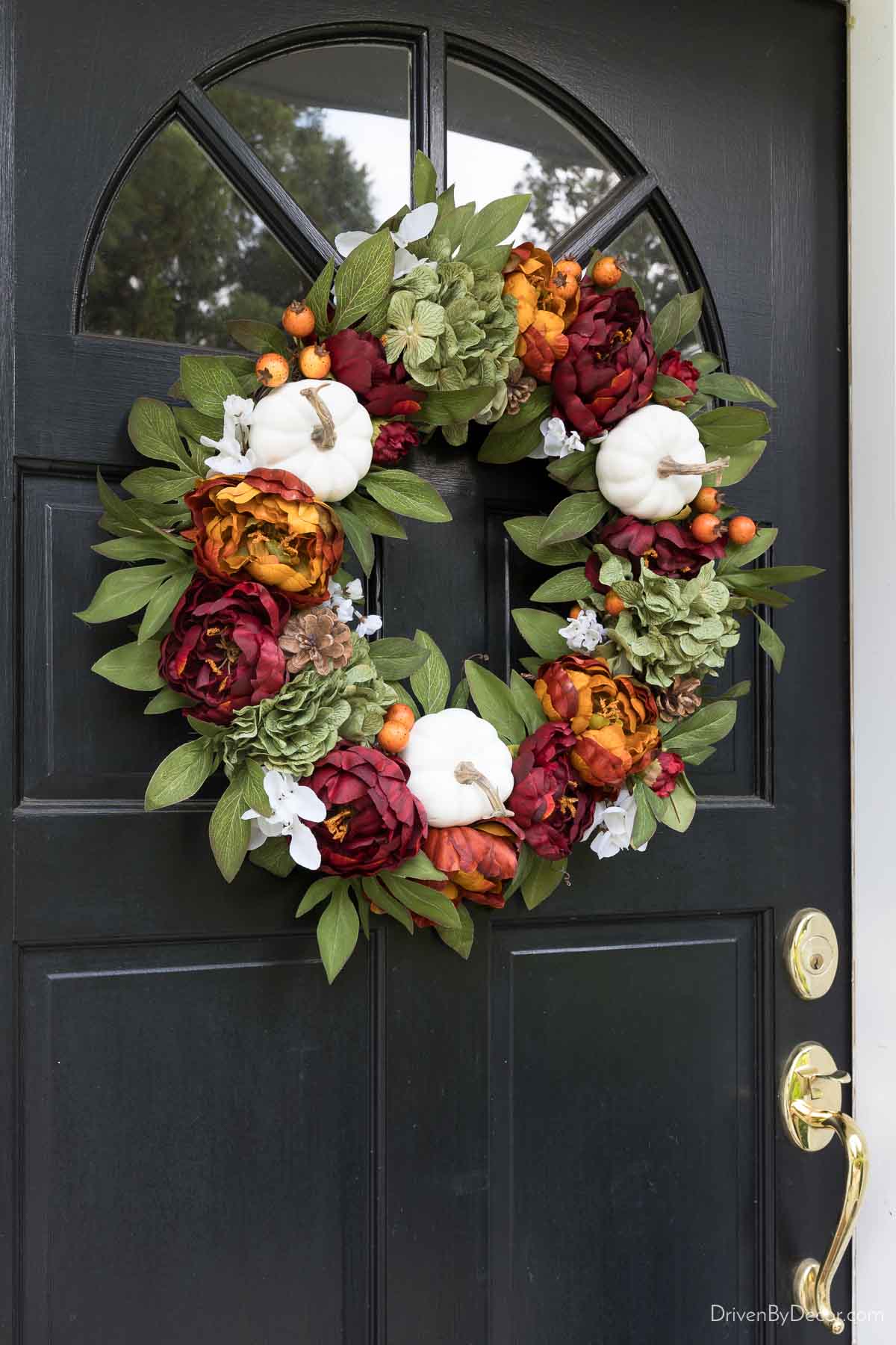 Fall wreath with white pumpkins, hydrangeas, and berries
