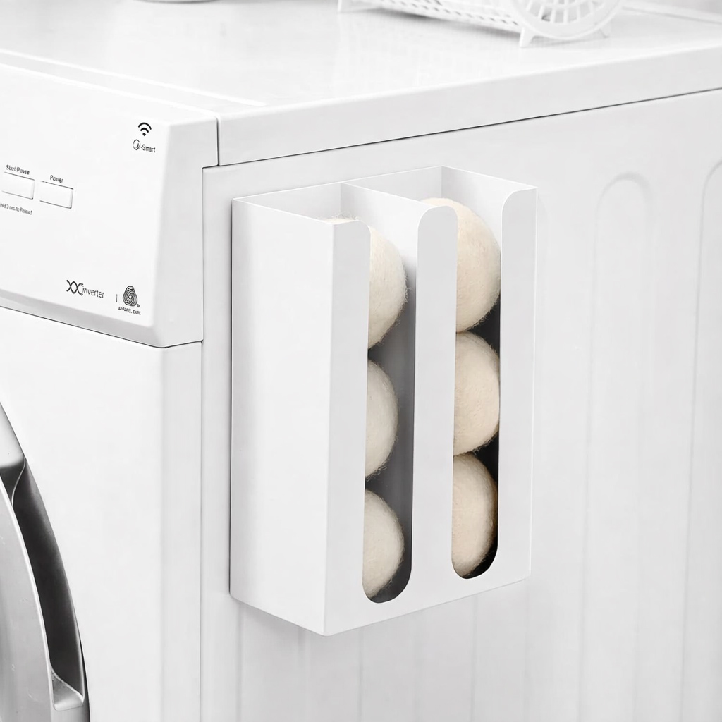 Magnetic dryer ball holder on side of dryer