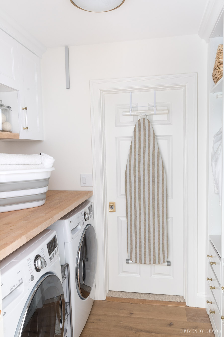 Free up space in your laundry room by hanging your ironing board on the back of the door!