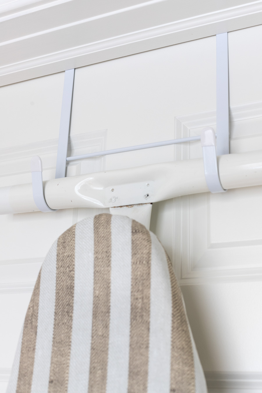 Over the door hanger for an ironing board - such a great space saver!