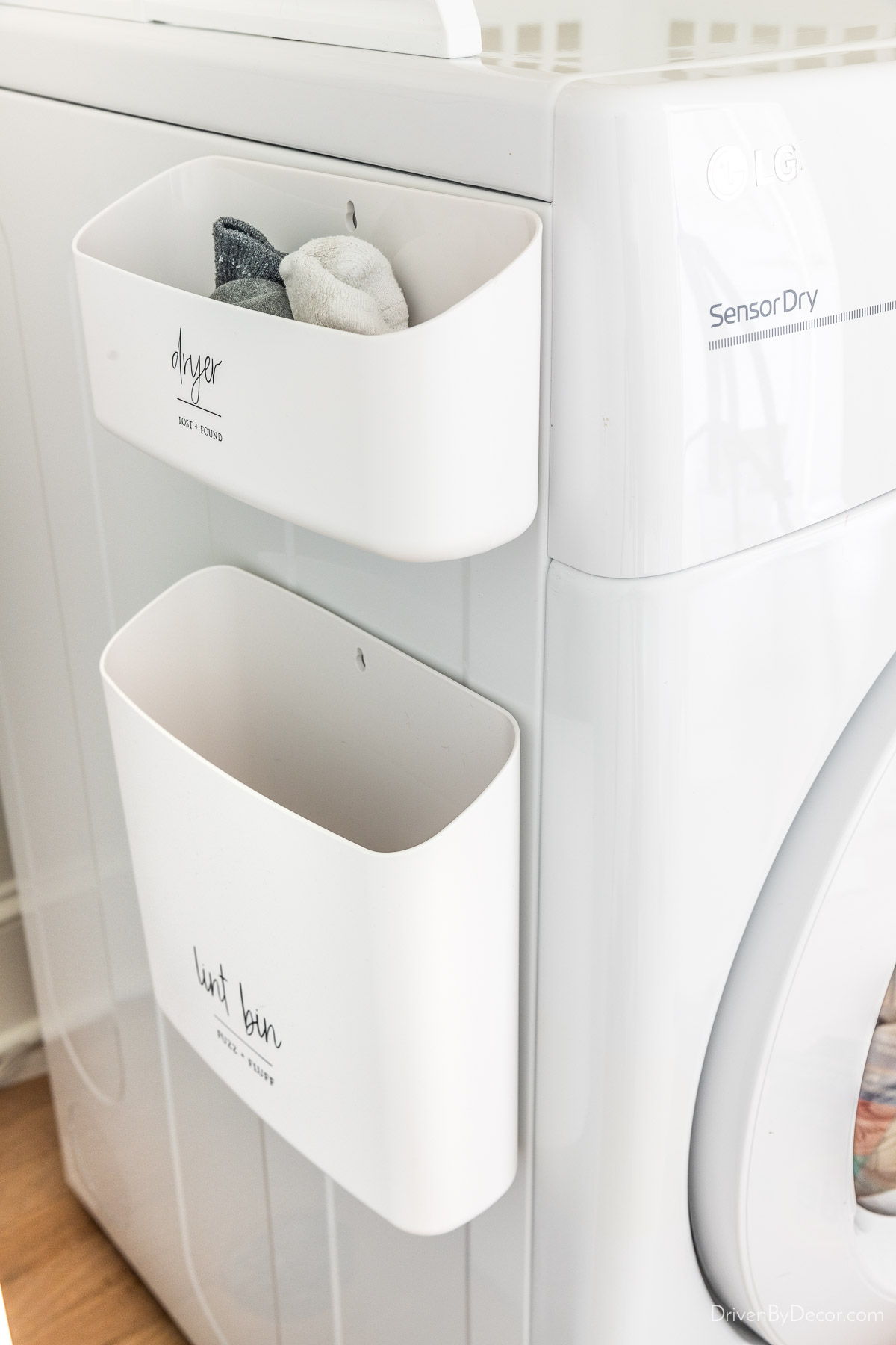 Magnetic bins for lint and unpaired socks on side of dryer