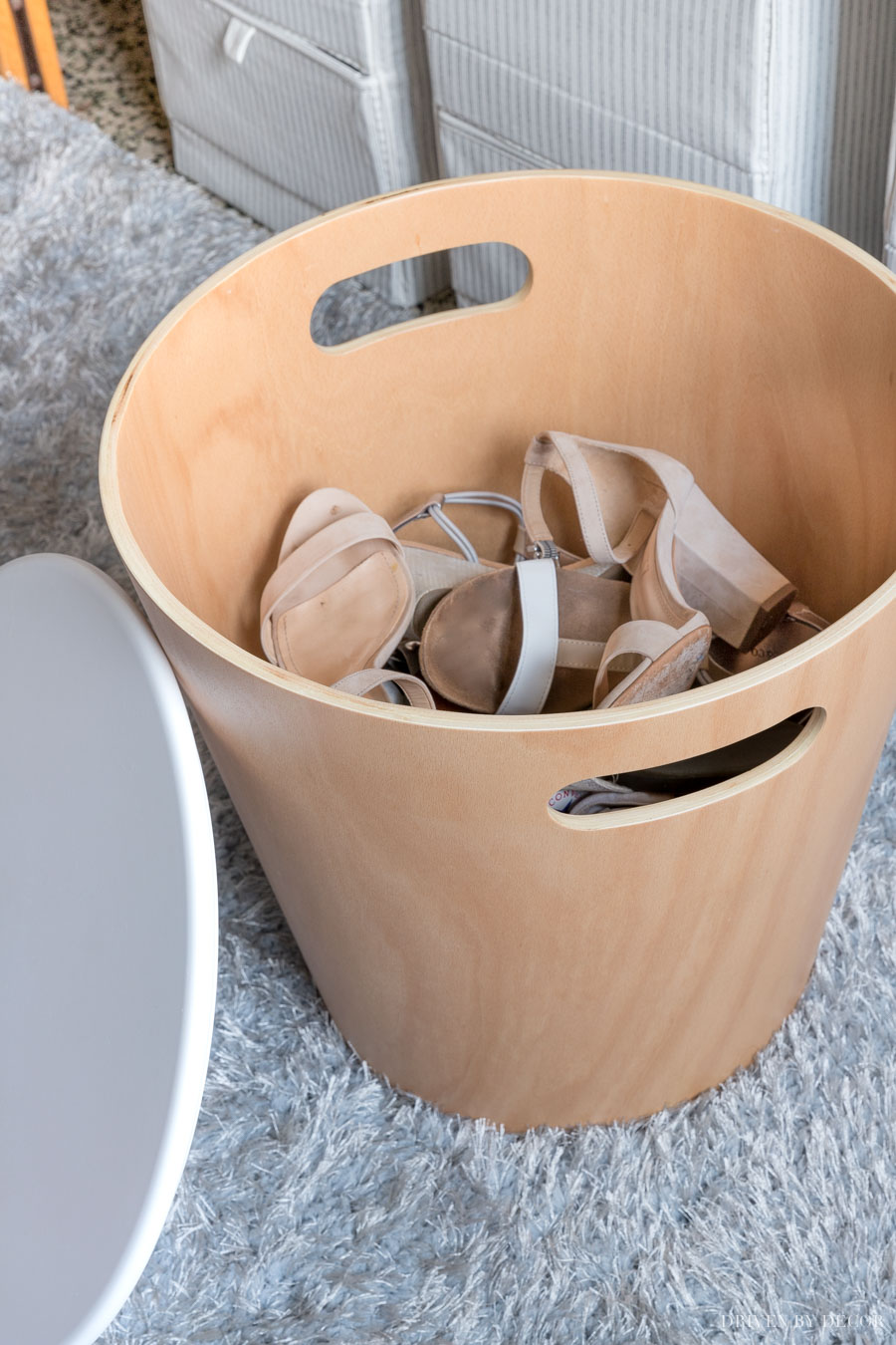 This cute wood storage stool is perfect for storing shoes in a college dorm room!