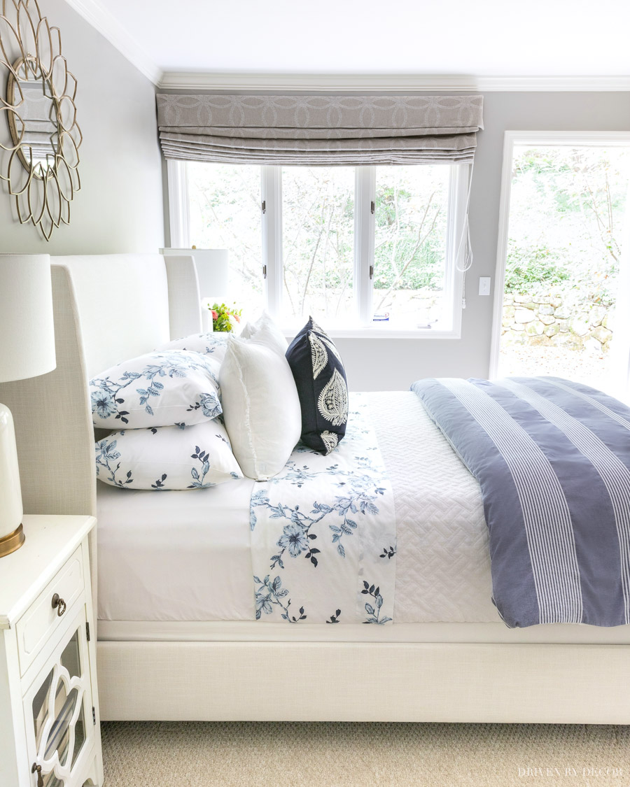 arranging cushions on bed