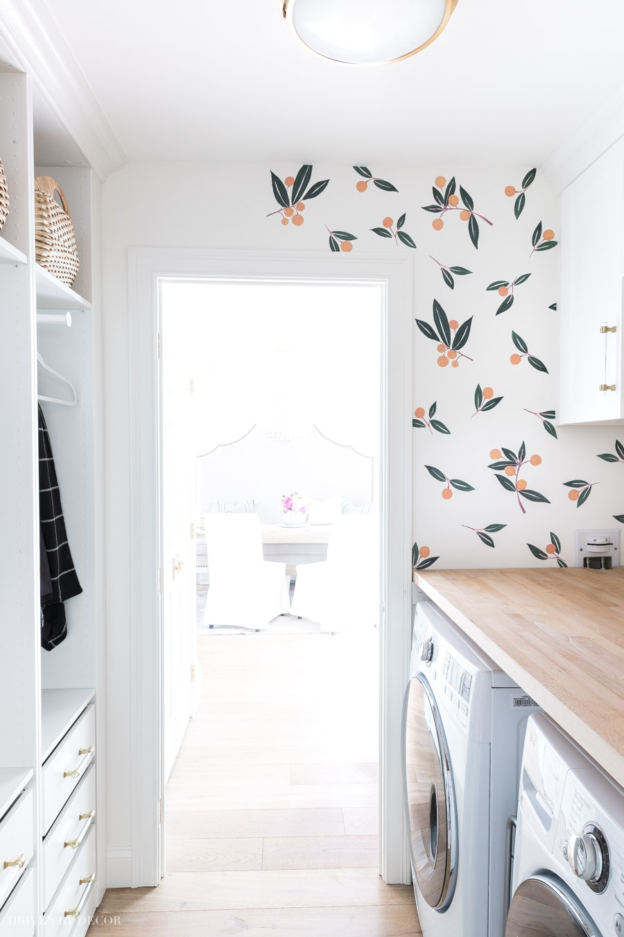 Installing our tangerine vinyl wall decals in the laundry room!